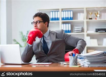 Angry aggressive businessman with boxing gloves