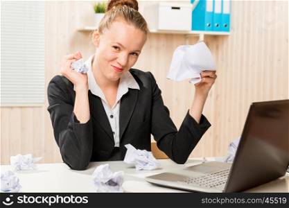angry and aggressive businesswoman crumples documents