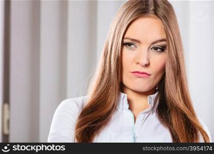 Angry and irritated business woman in office.. Stress and emotions in business. Professional woman in uniform work in office unhappy and nervous