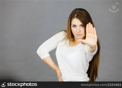 Angry apodicticity woman showing stop sign gesture with open hand, denying something,. Angry apodicticity woman showing stop with hand