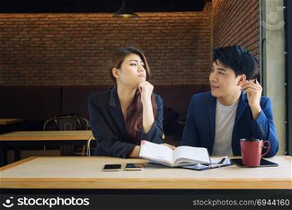 angry beautiful young asian business woman and professional man in meeting room office