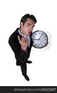 Angry boss holding clock