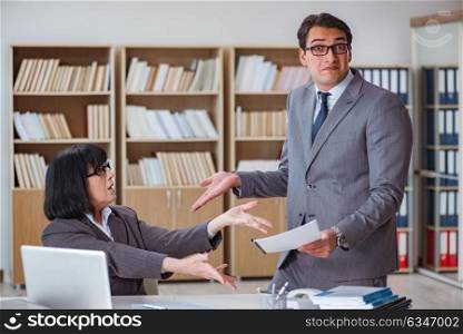 Angry boss reprimanding fellow employee