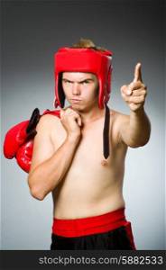 Angry boxer against grey background