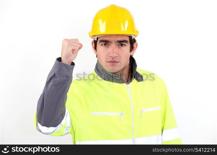 Angry builder waving fist