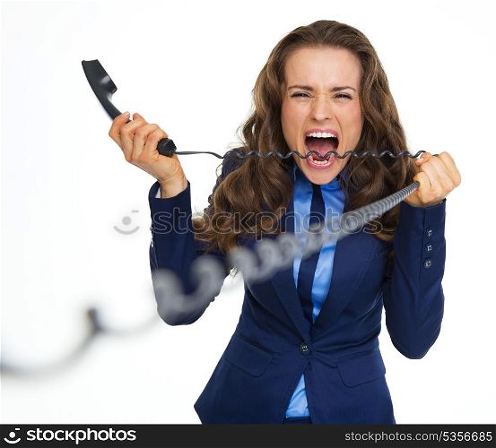 Angry business woman biting phone cord