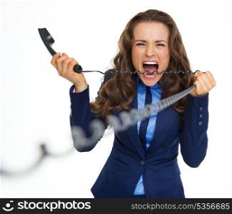 Angry business woman biting phone cord