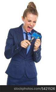 Angry business woman cutting credit card with scissors