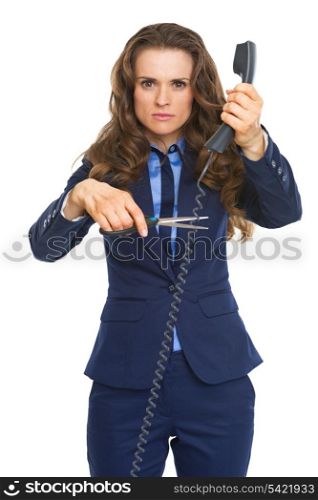 Angry business woman cutting phone wire