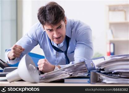 Angry businessman frustrated with too much work