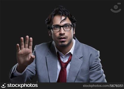 Angry businessman gesturing over black background