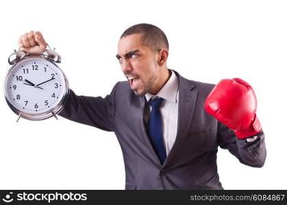 Angry businessman hitting clock isolated on white