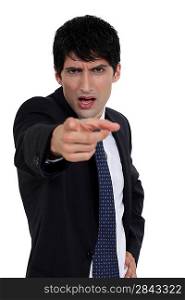 Angry businessman pointing at you