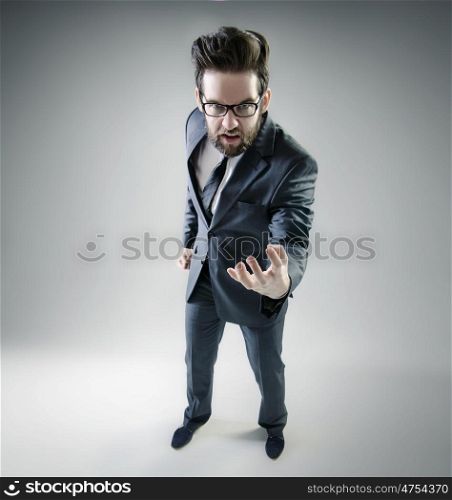 Angry businessman posing in elegant suit