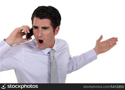 angry businessman talking on his cell