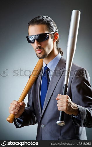 Angry businessman with bat on white