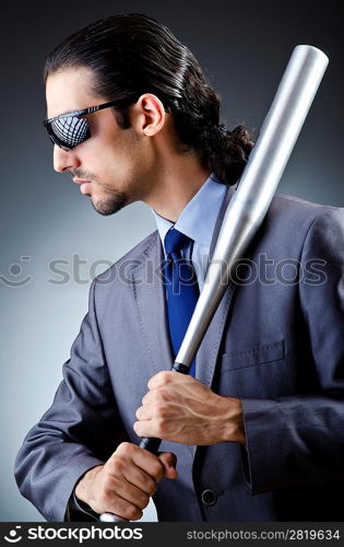 Angry businessman with bat on white