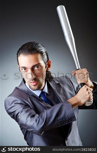 Angry businessman with bat on white