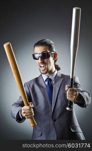 Angry businessman with bat on white