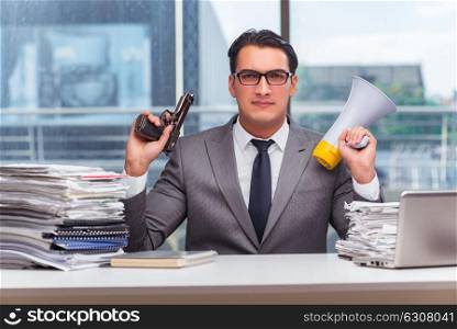 Angry businessman with gun in the office