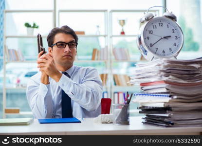 Angry businessman with gun thinking of committing suicide