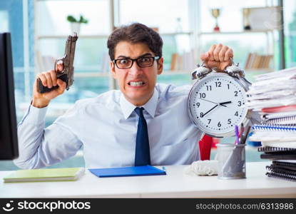 Angry businessman with gun thinking of committing suicide