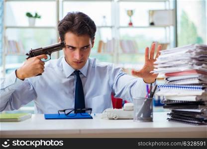 Angry businessman with gun thinking of committing suicide. The angry businessman with gun thinking of committing suicide