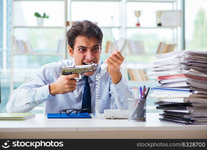 Angry businessman with gun thinking of committing suicide. The angry businessman with gun thinking of committing suicide