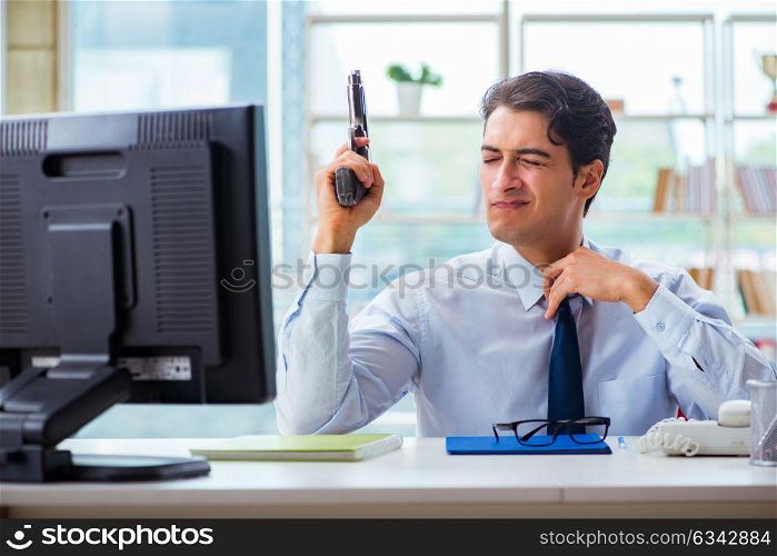 Angry businessman with gun thinking of committing suicide. The angry businessman with gun thinking of committing suicide
