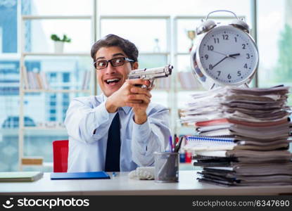 Angry businessman with gun thinking of committing suicide. The angry businessman with gun thinking of committing suicide