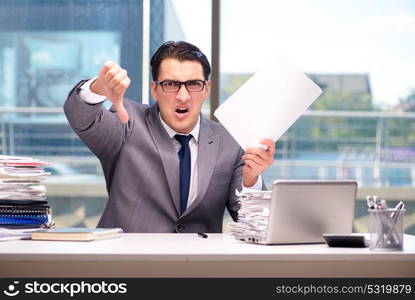 Angry businessman with too much work in office