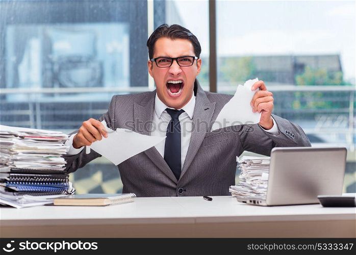 Angry businessman with too much work in office