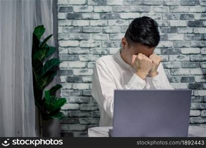 Angry businessman working at office with laptop on desk