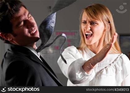 angry businesswoman is slapping across the businessman&acute;s face