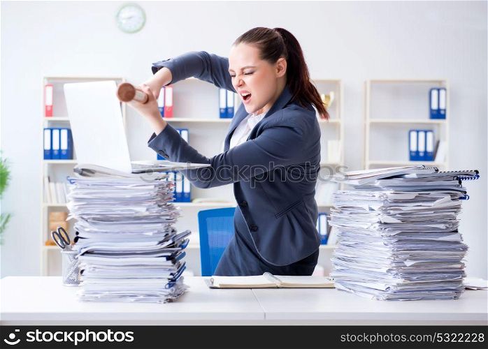 Angry businesswoman with baseball bat in office