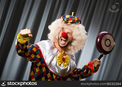 Angry clown with frying pan