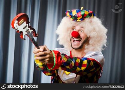 Angry clown with guitar in funny concept