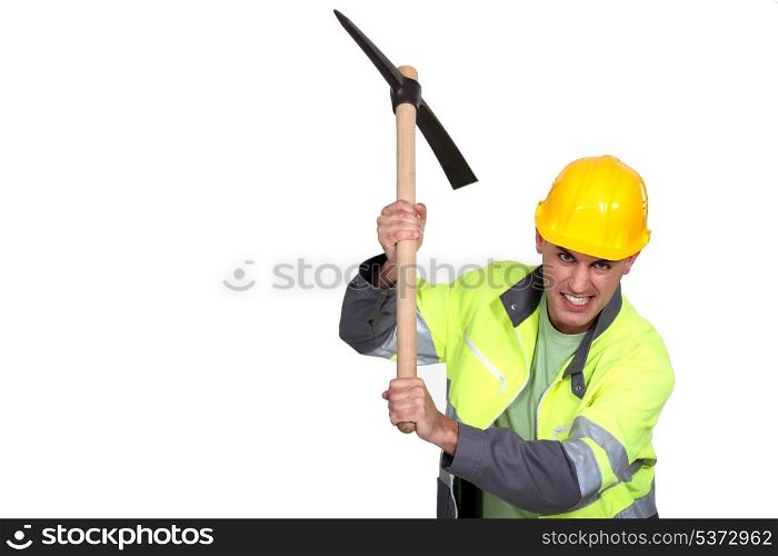 Angry construction worker holding a pickaxe