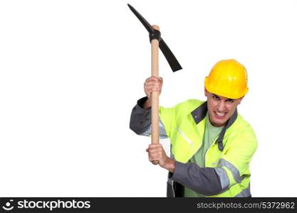 Angry construction worker holding a pickaxe
