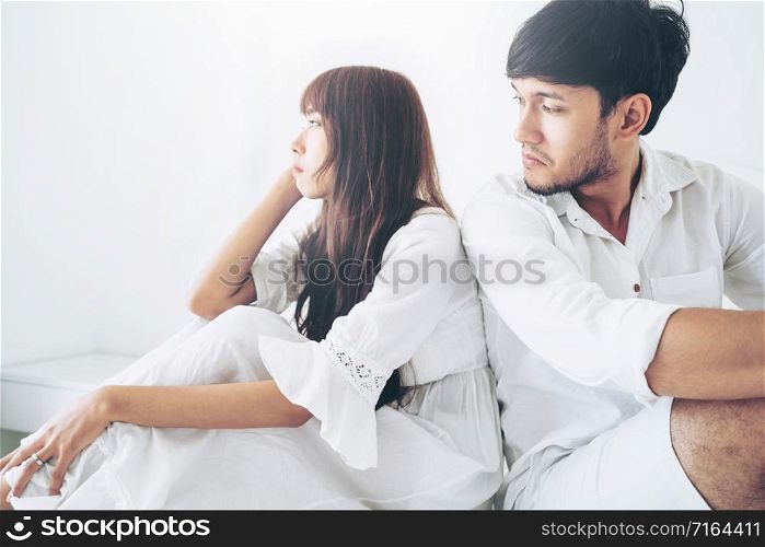 Angry couple having family problem while sitting at home bedroom.. Angry couple having family problem.