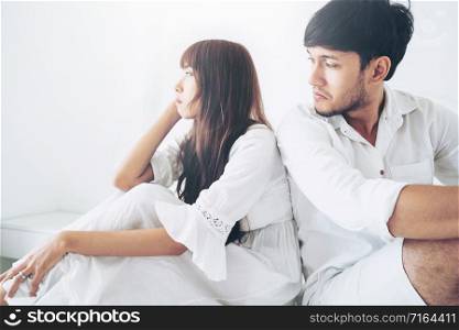 Angry couple having family problem while sitting at home bedroom.. Angry couple having family problem.