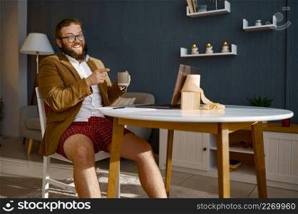 Angry freelance businessman pointing finger to laptop screen scolding blaming partner on video call. Angry freelance businessman pointing finger to laptop