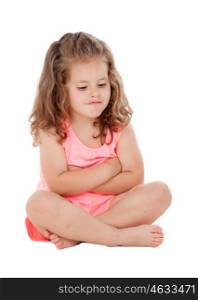 Angry little girl with three year old sitting on the floor isolated on a white background