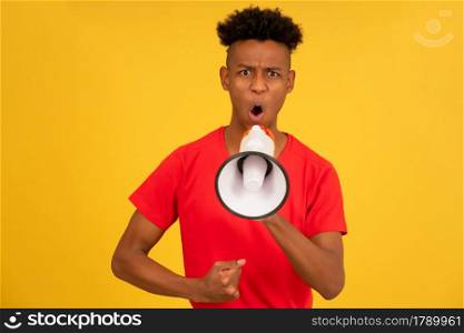 Angry man screaming through a megaphone to raise his voice up and protest something.