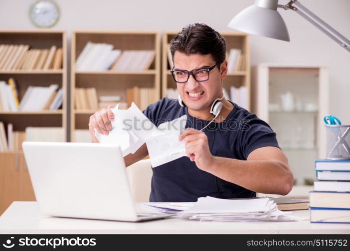 Angry man tearing apart his paperwork due to stress