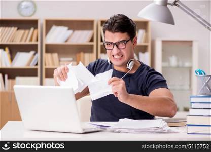 Angry man tearing apart his paperwork due to stress