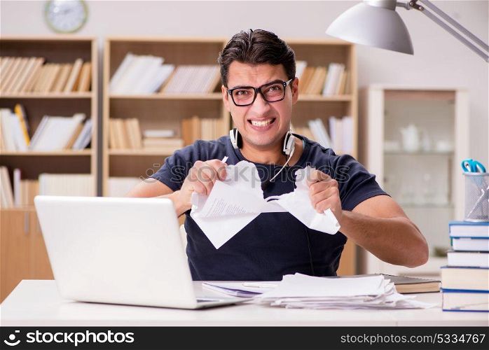 Angry man tearing apart his paperwork due to stress