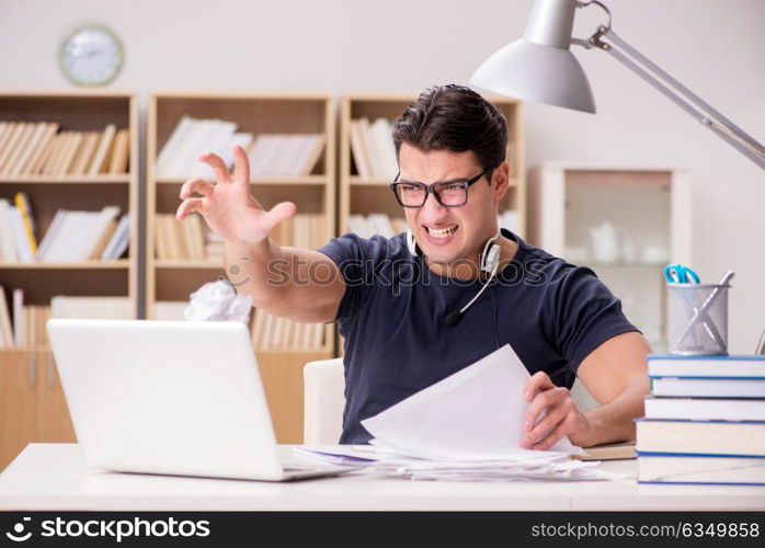 Angry man tearing apart his paperwork due to stress