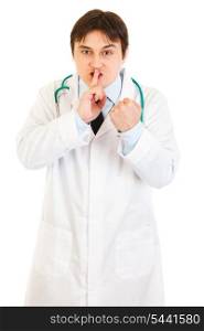 Angry medical doctor with finger at mouth and threaten with fist isolated on white&#xA;