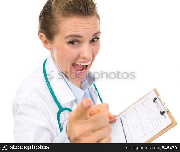 Angry medical doctor woman with clipboard pointing in camera